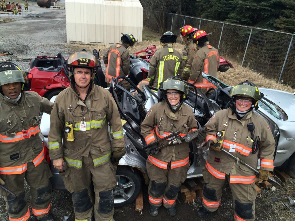 Text Shows Mike as a Fire Captain with the crew during Auto Ex training