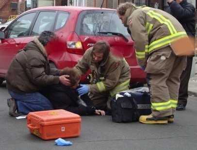 Mike as firefighter tending to a casulty.
